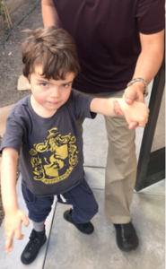 Dad holding hand of boy with Smith-Kingsmore syndrome