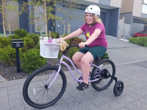Teen with Smith-Kingsmore syndrome on bike
